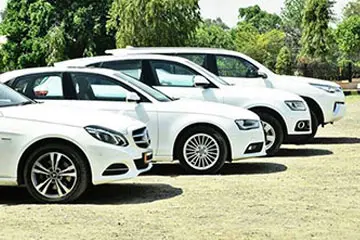 White luxury SUV fleet Chennai premium car rental parking area